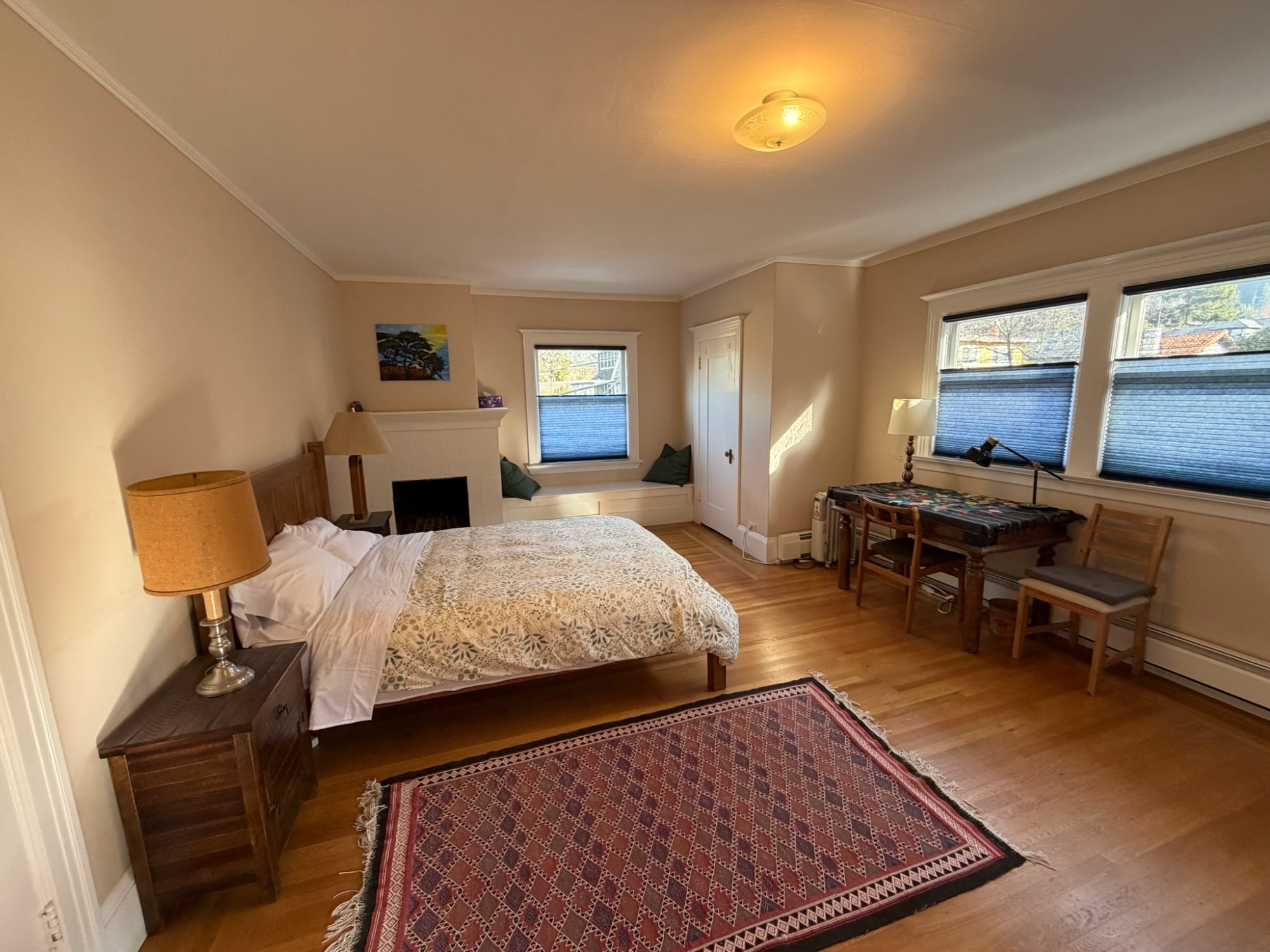 East bedroom showing desk/workspace and multiple windows