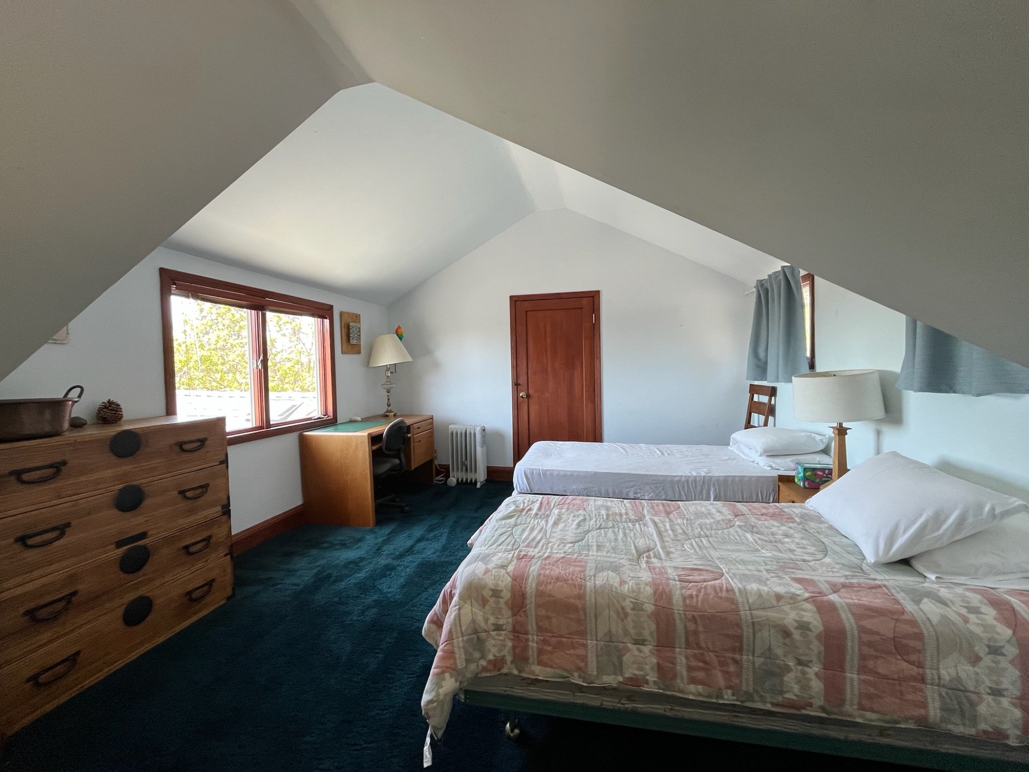 Attic bedroom with two twin beds and desk