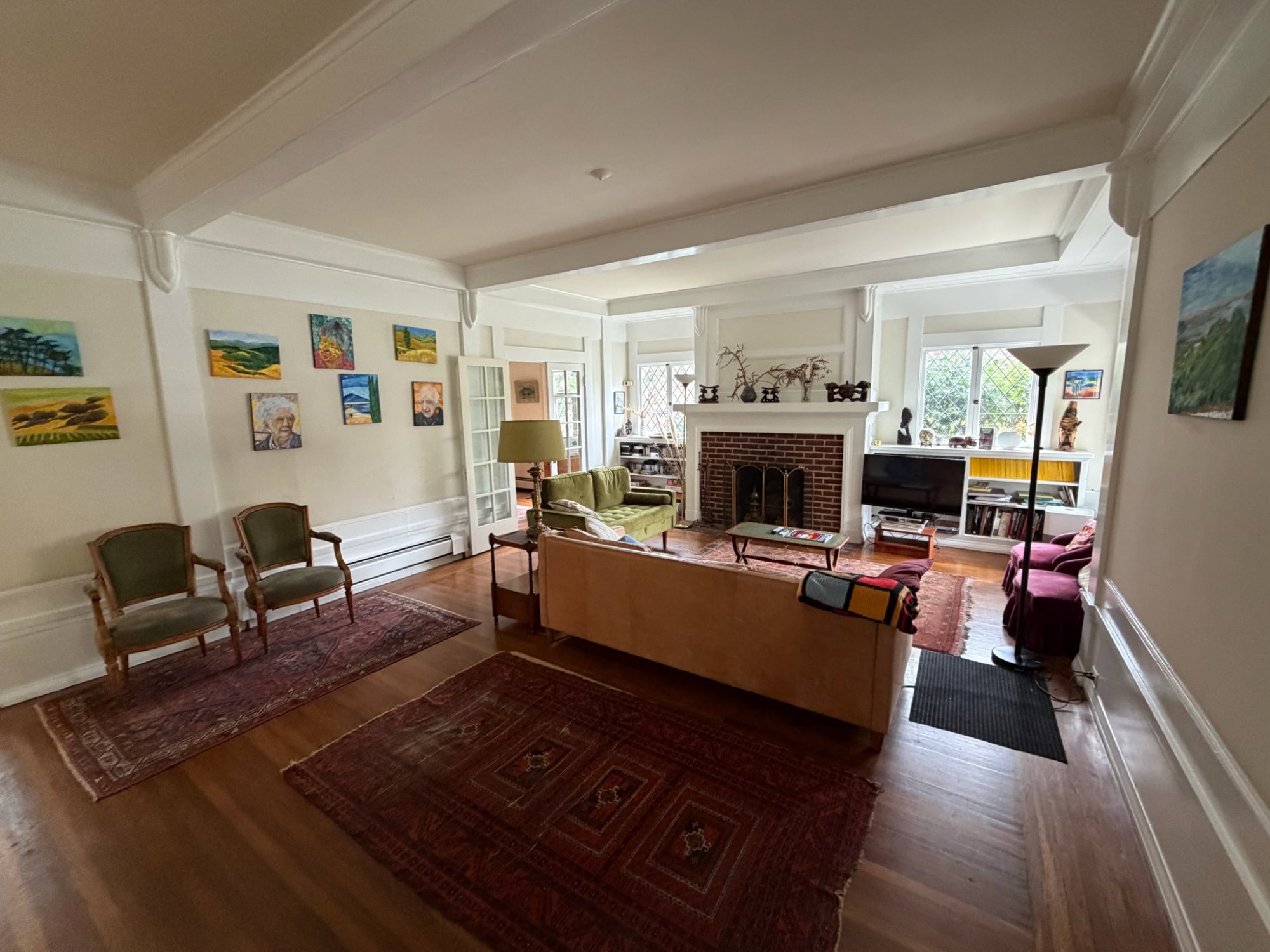 Living room with art wall and hardwood floors