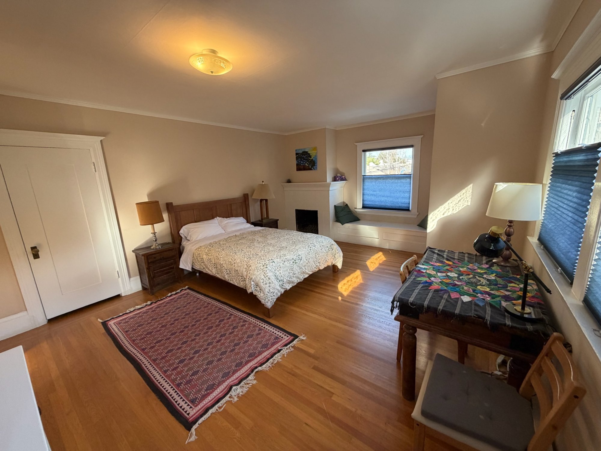 East queen bedroom with fireplace and window seat