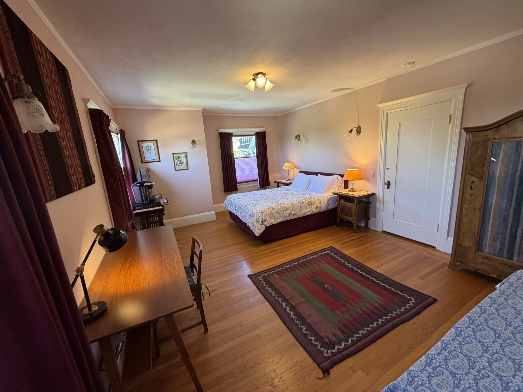 West bedroom from desk side showing bed and armoire