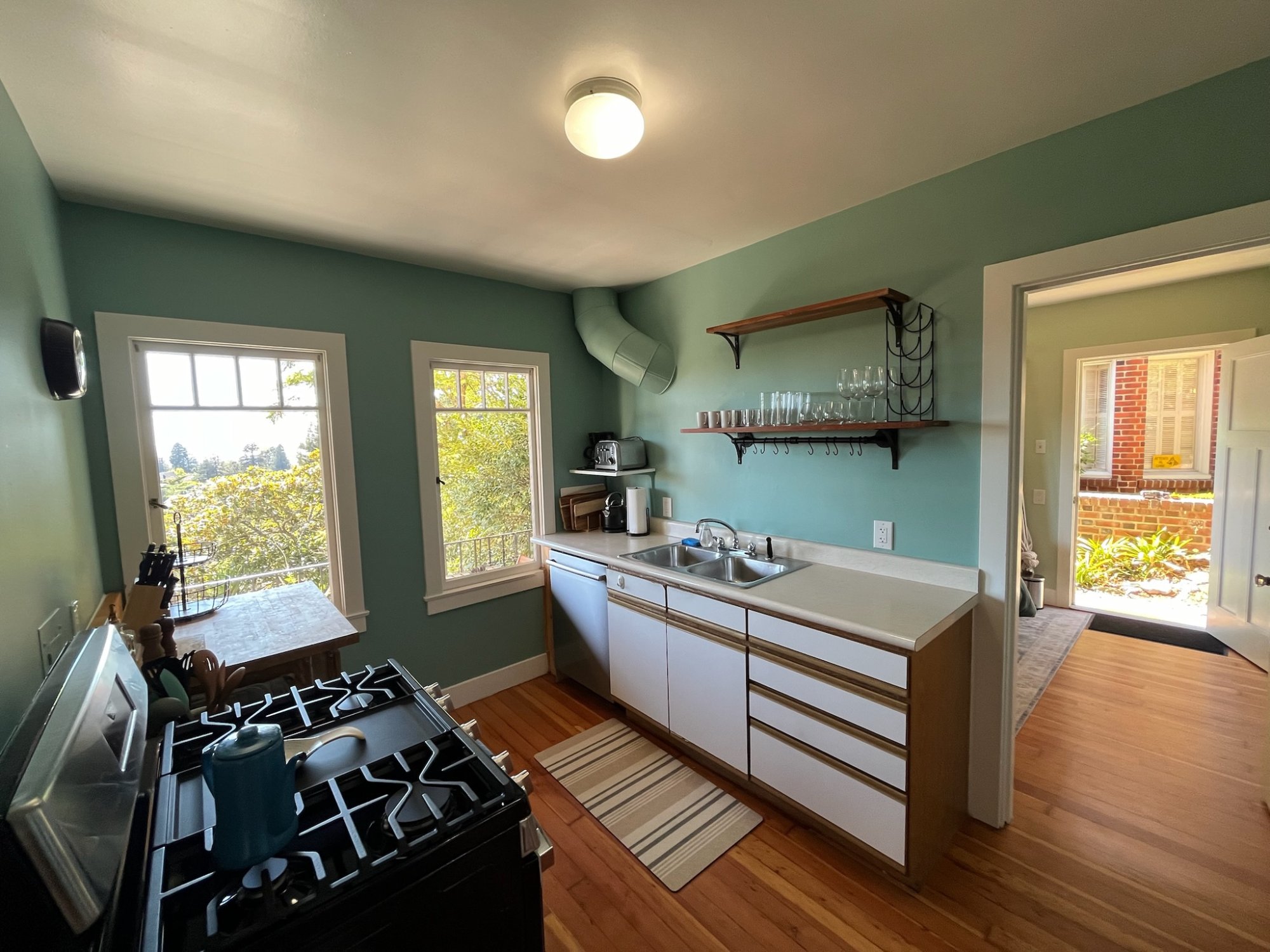 Kitchen with double sink, dishwasher and open shelving