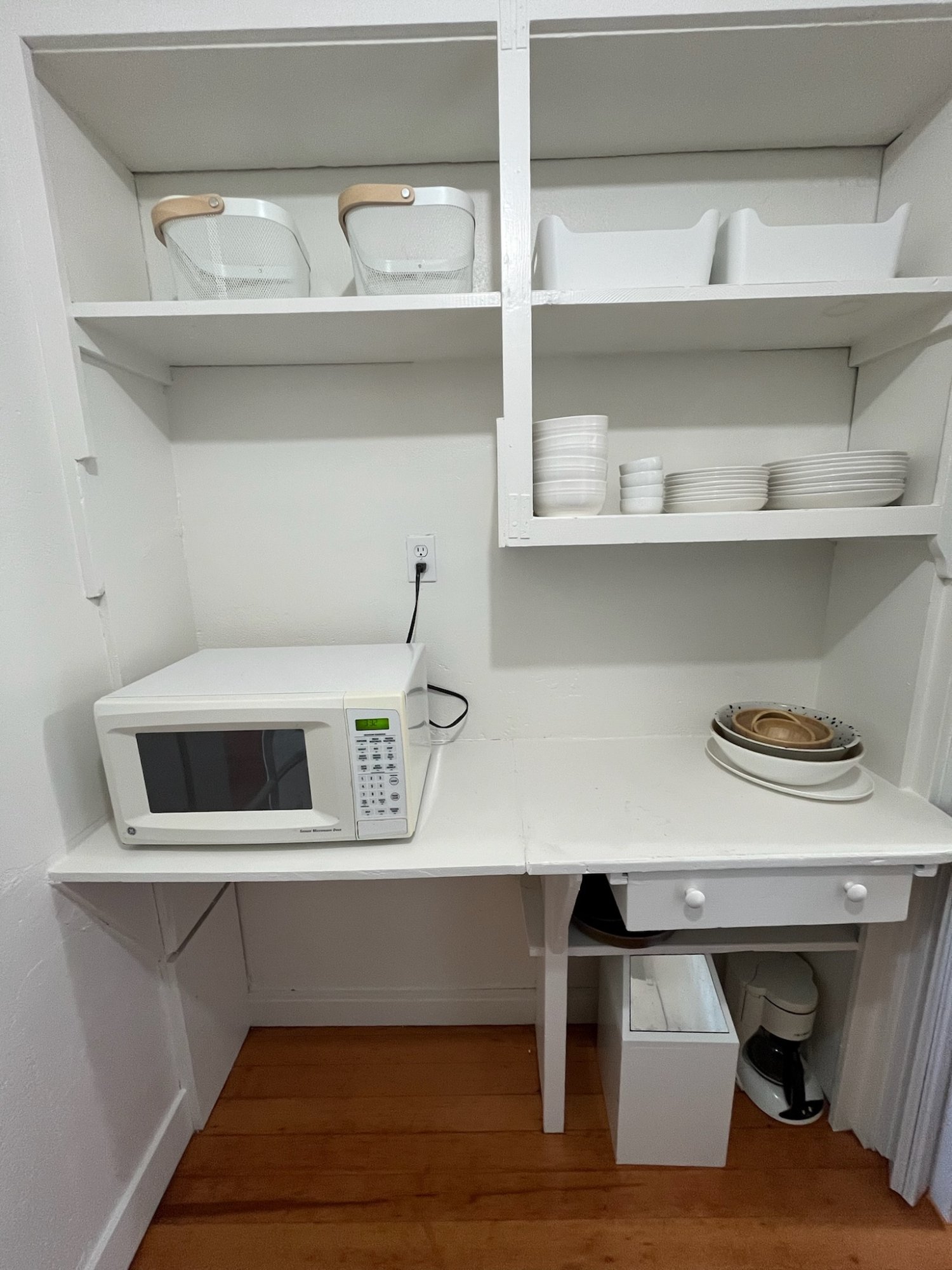 Pantry with microwave, dishes and full kitchen supplies