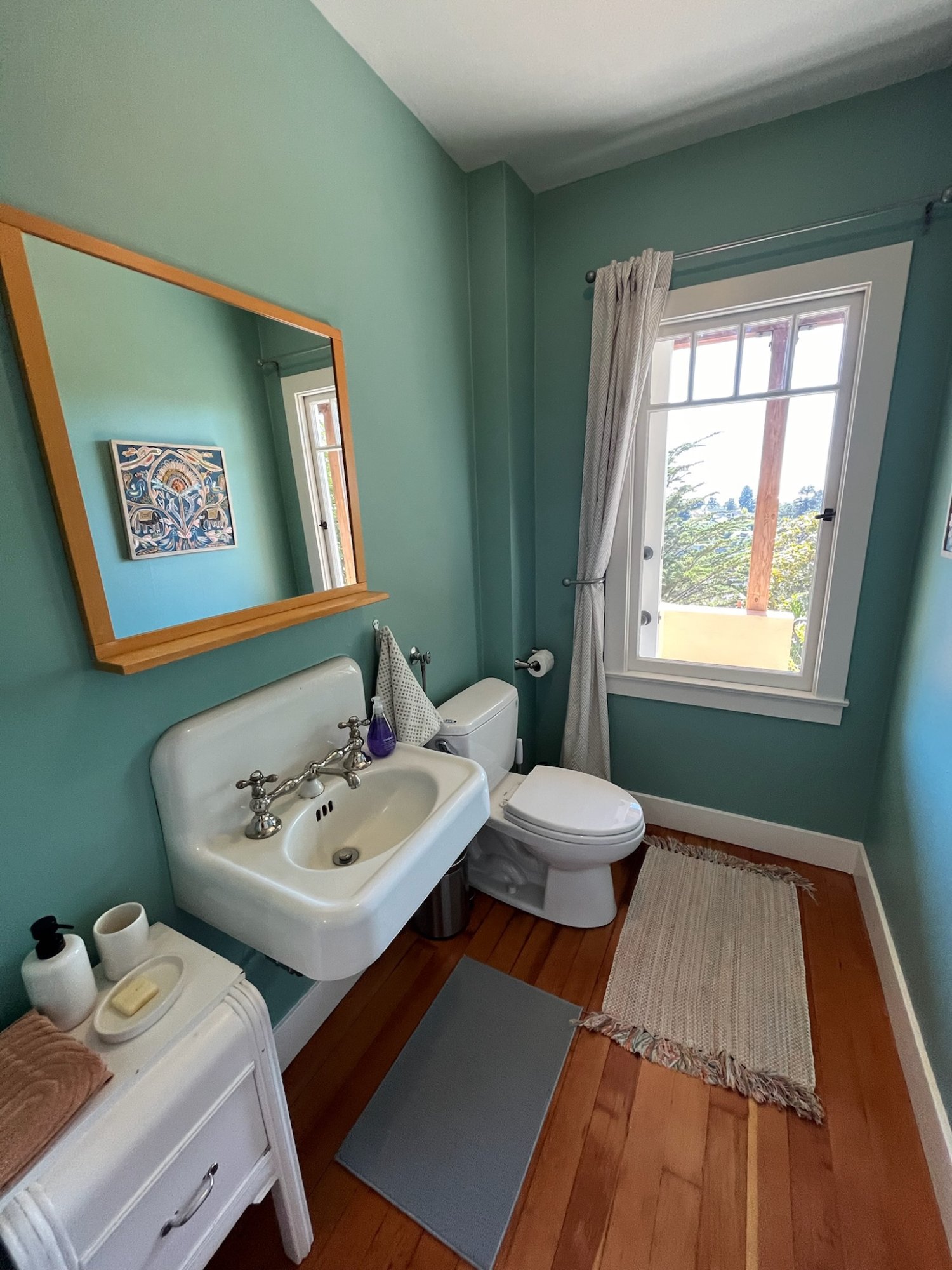 Charming bathroom with classic pedestal sink and garden window