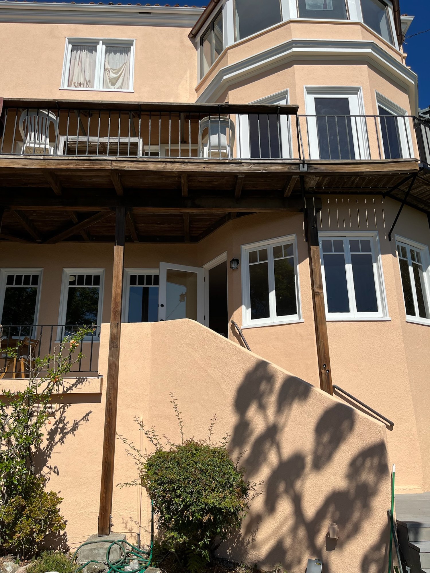 Side entry and private deck of the apartment