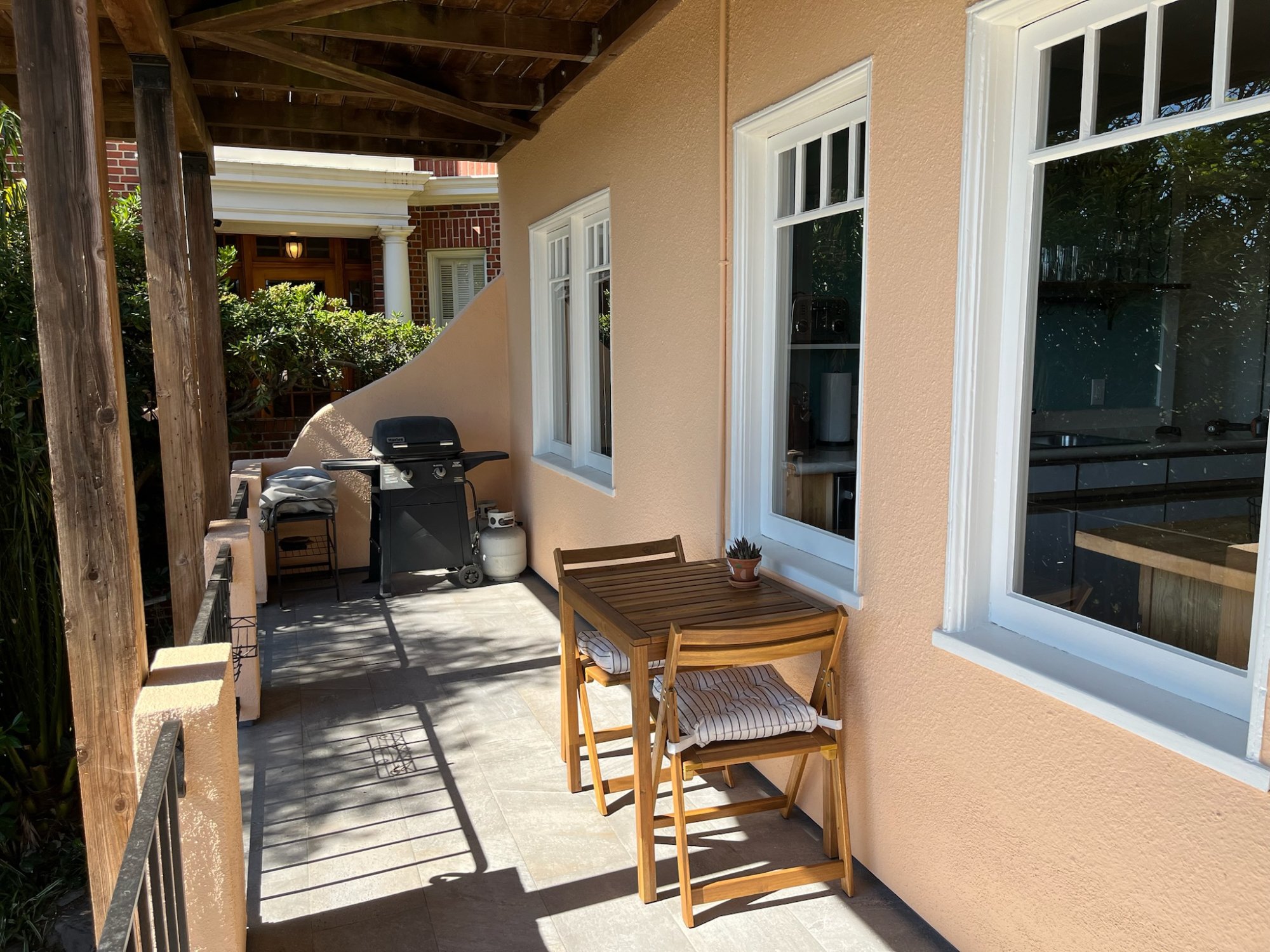 Private deck with outdoor dining table and BBQ grill