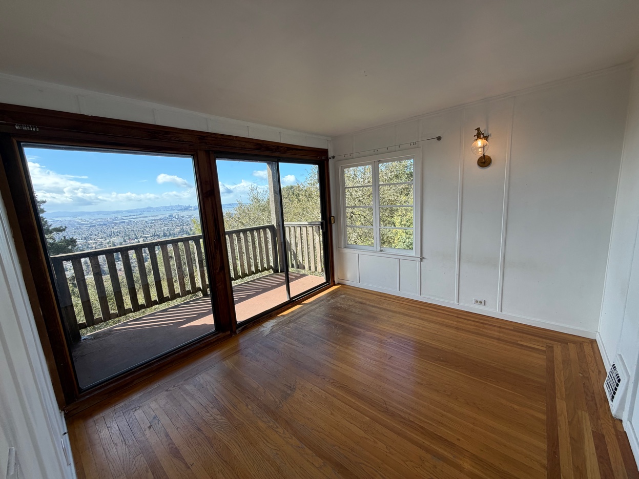 Sunlit bedroom with panoramic Bay and SF views
