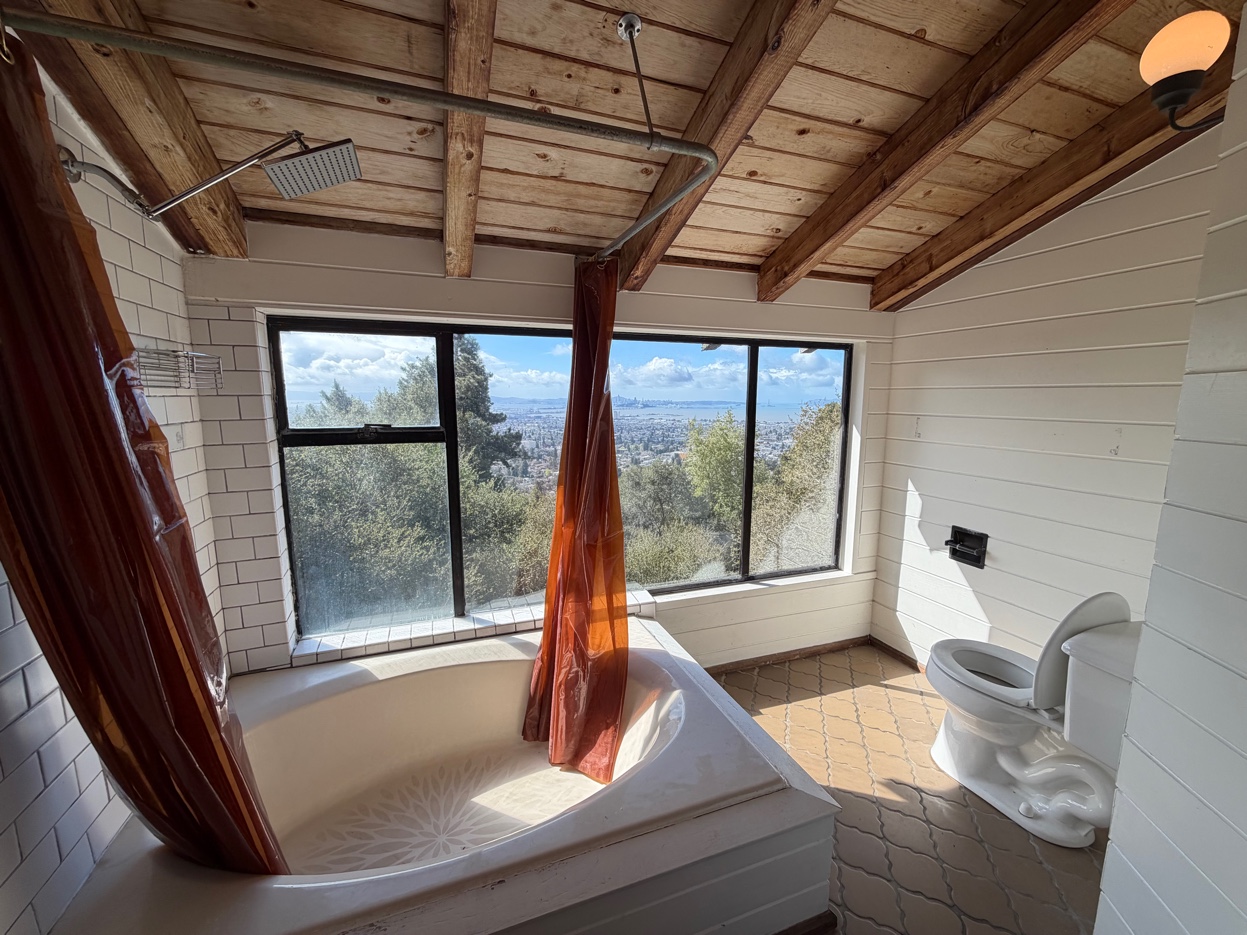 Master bathroom soaking tub with Bay view window and toilet
