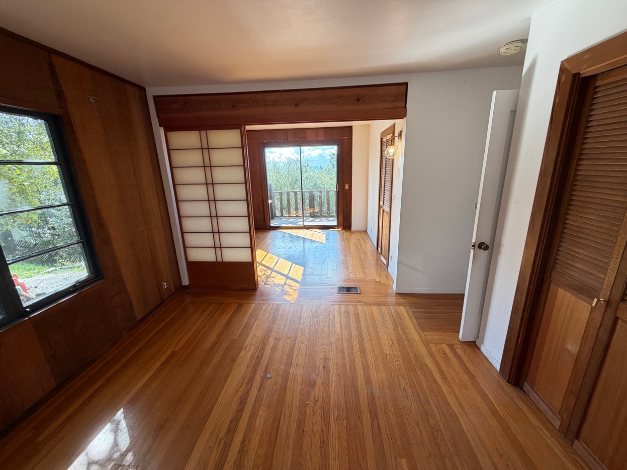 Bedroom with shoji sliding doors and hardwood floors