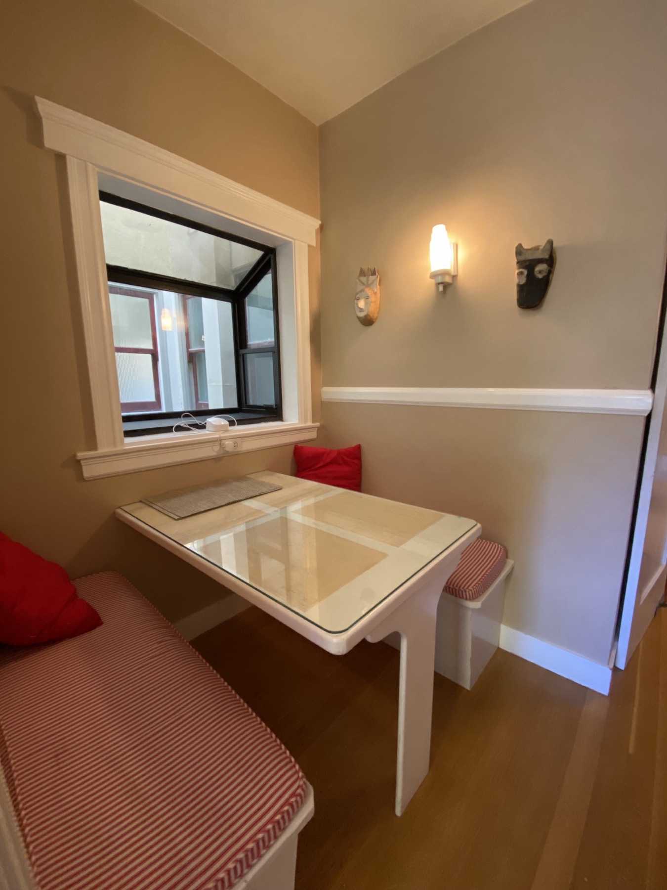 Charming breakfast nook banquette with red cushions