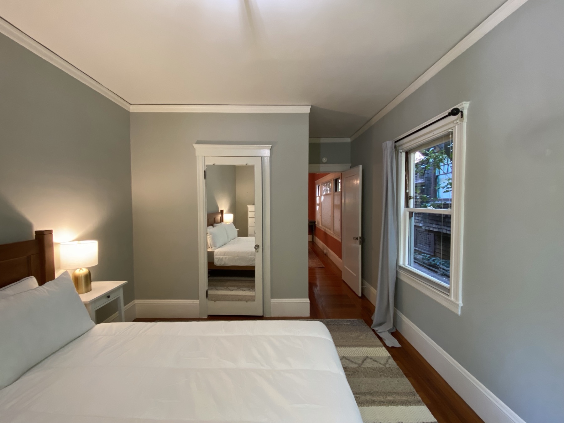 Bedroom with closet, natural light, and view into hallway