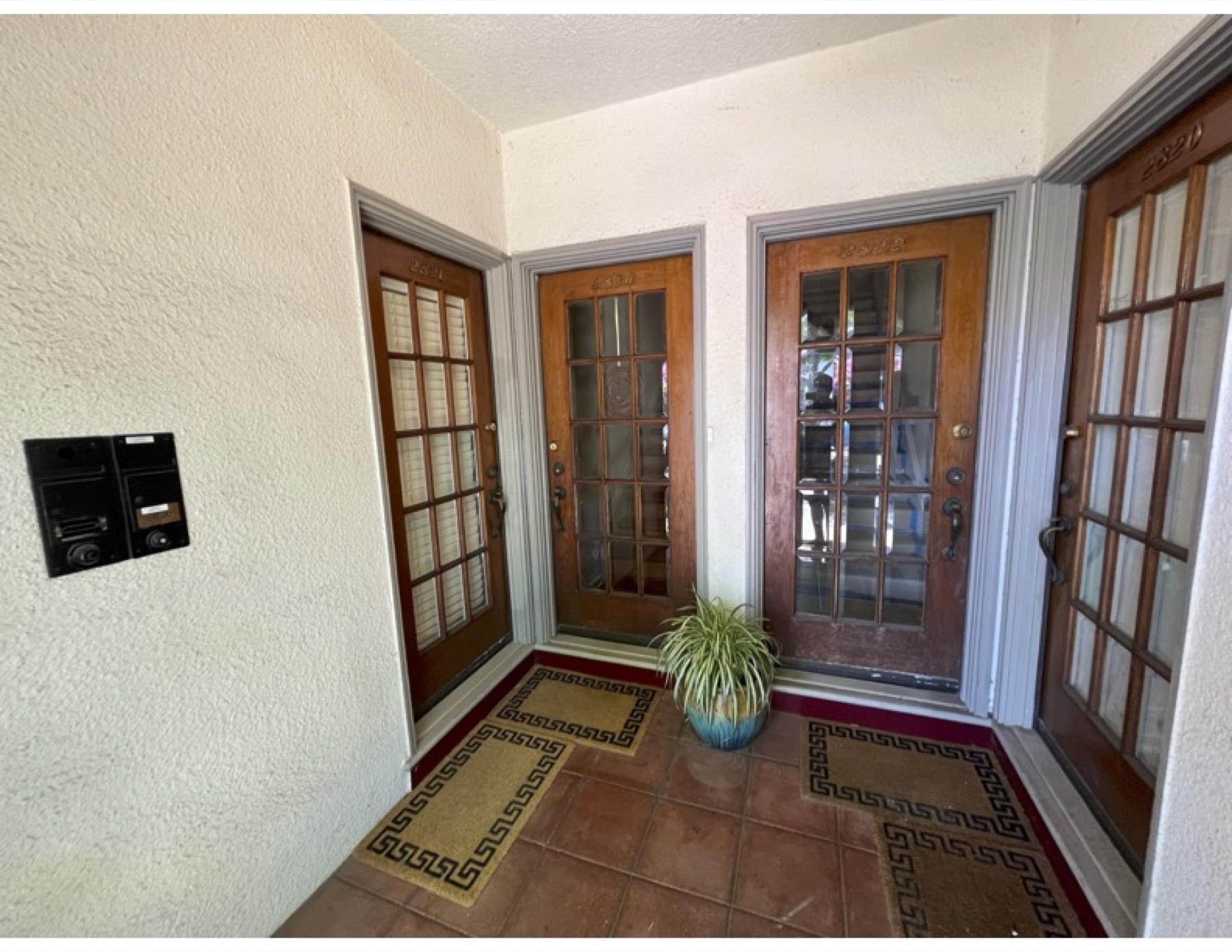 Wood-paneled entry vestibule with French doors