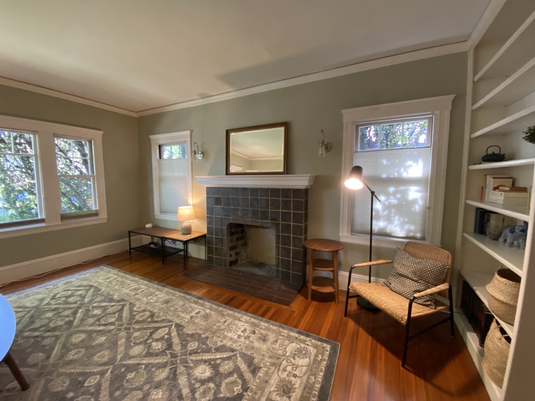 Living room with tiled fireplace and built-in bookshelves