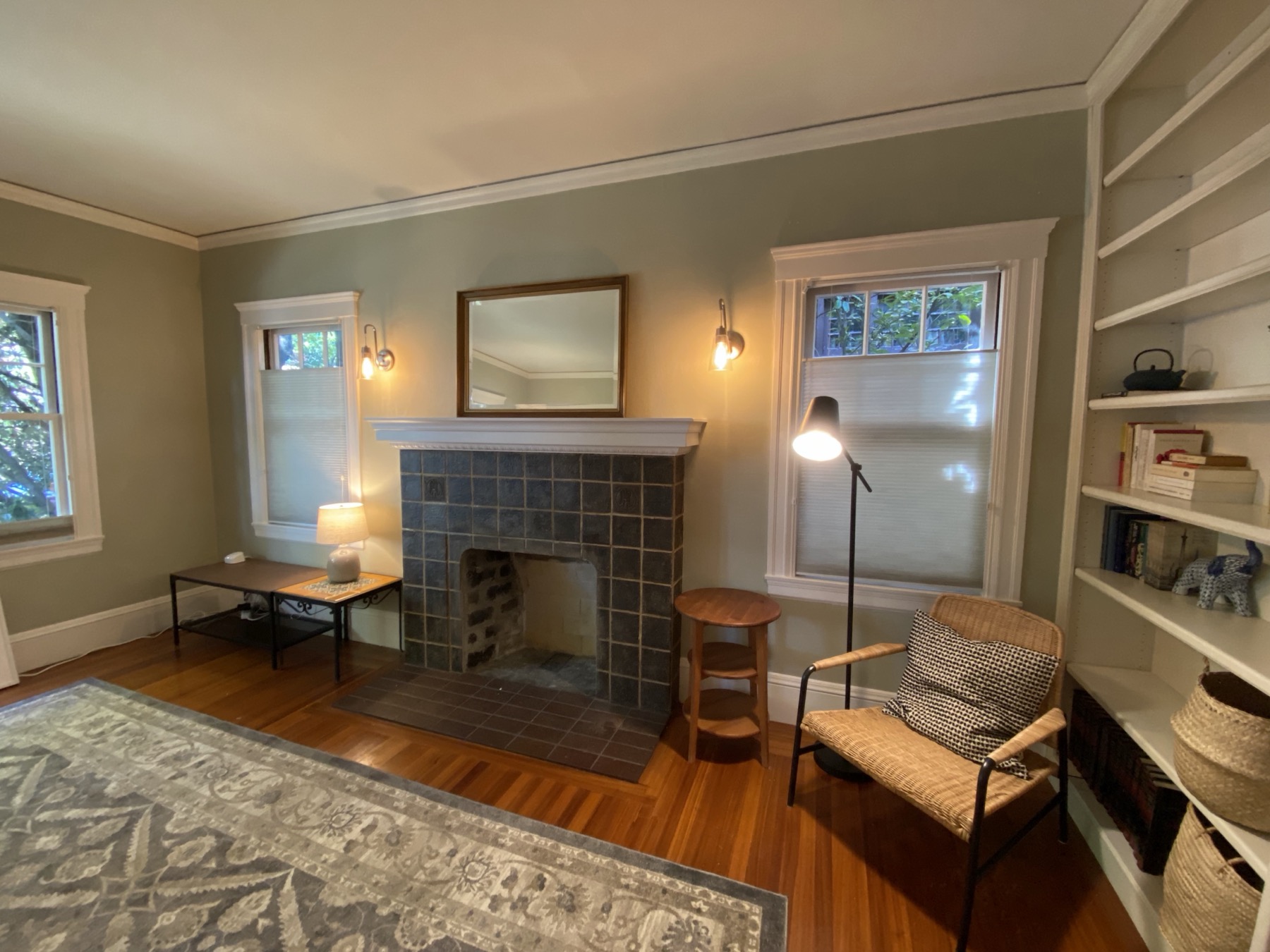 Sitting area with fireplace, bookshelves, and period details