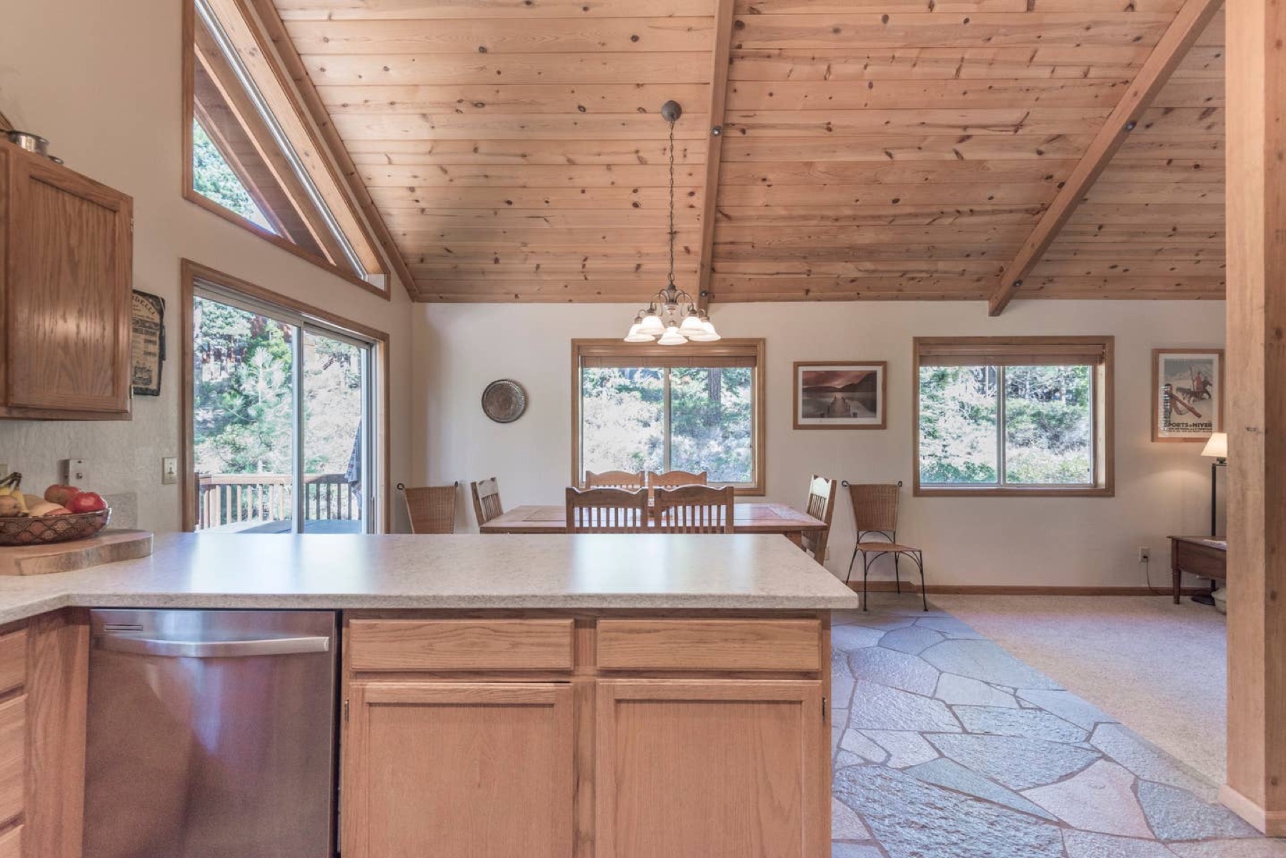 Kitchen island and dining area with vaulted ceiling