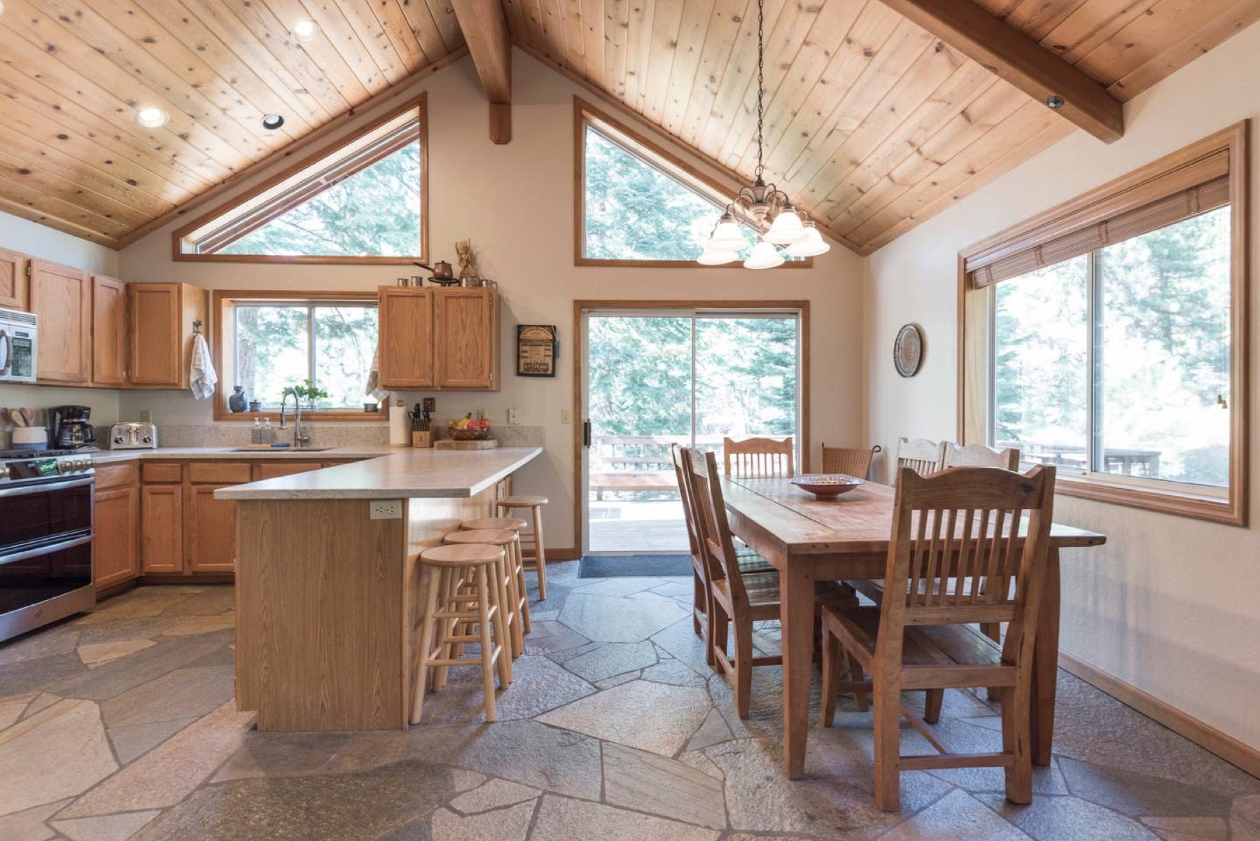 Kitchen with island, stone floor, and open layout