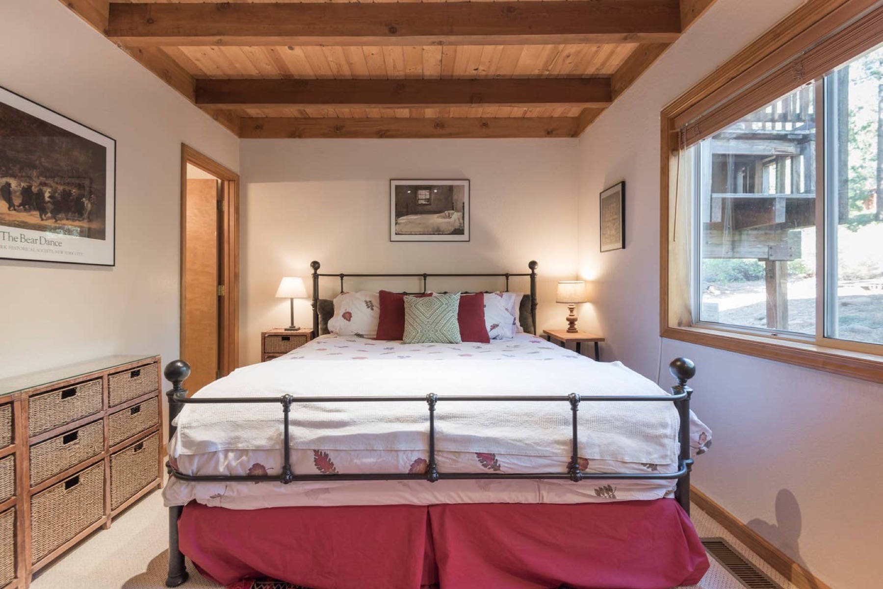 Queen bedroom with iron bed frame and wicker nightstands