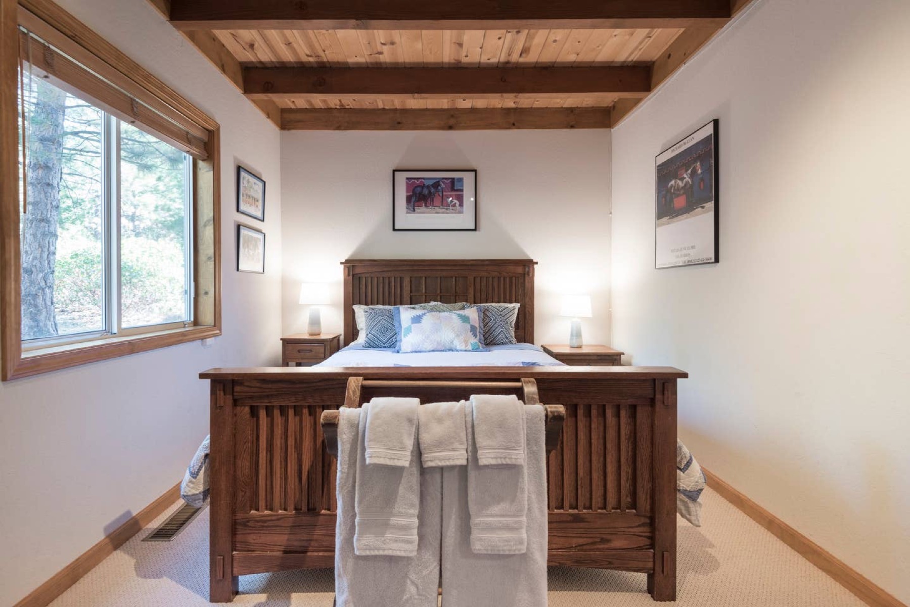 Queen bedroom with mission-style bed and vaulted wood ceiling