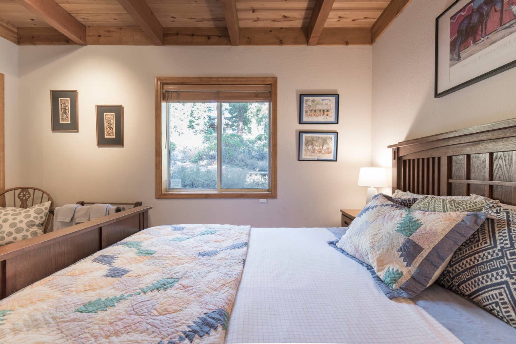 Bedroom with exposed beams and quilted bedding